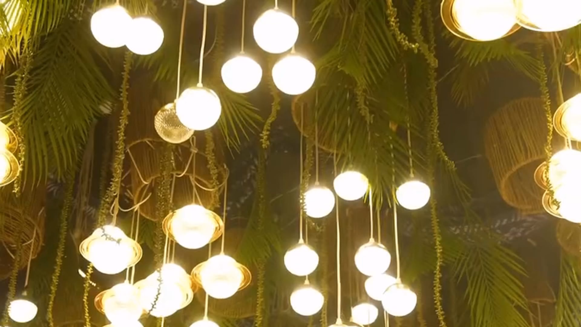 A ceiling of lit glass lanterns hung among trailing greenery, the light catching the leaves above a gala set for the Dr Teal's Relax & Recover launch